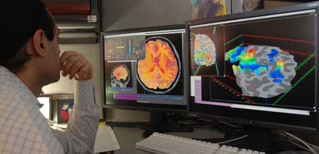 Researcher checking fMRI images - By NIMH - US Department of Health and Human Services: National Institute of Mental Health, Public Domain